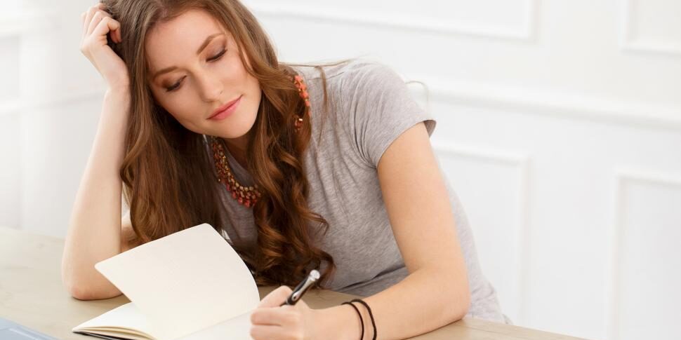 student.-attractive-girl-by-the-table-writing assignment writing tips